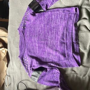 Long sleeve with stones on the shoulder with a big black ring around the arm